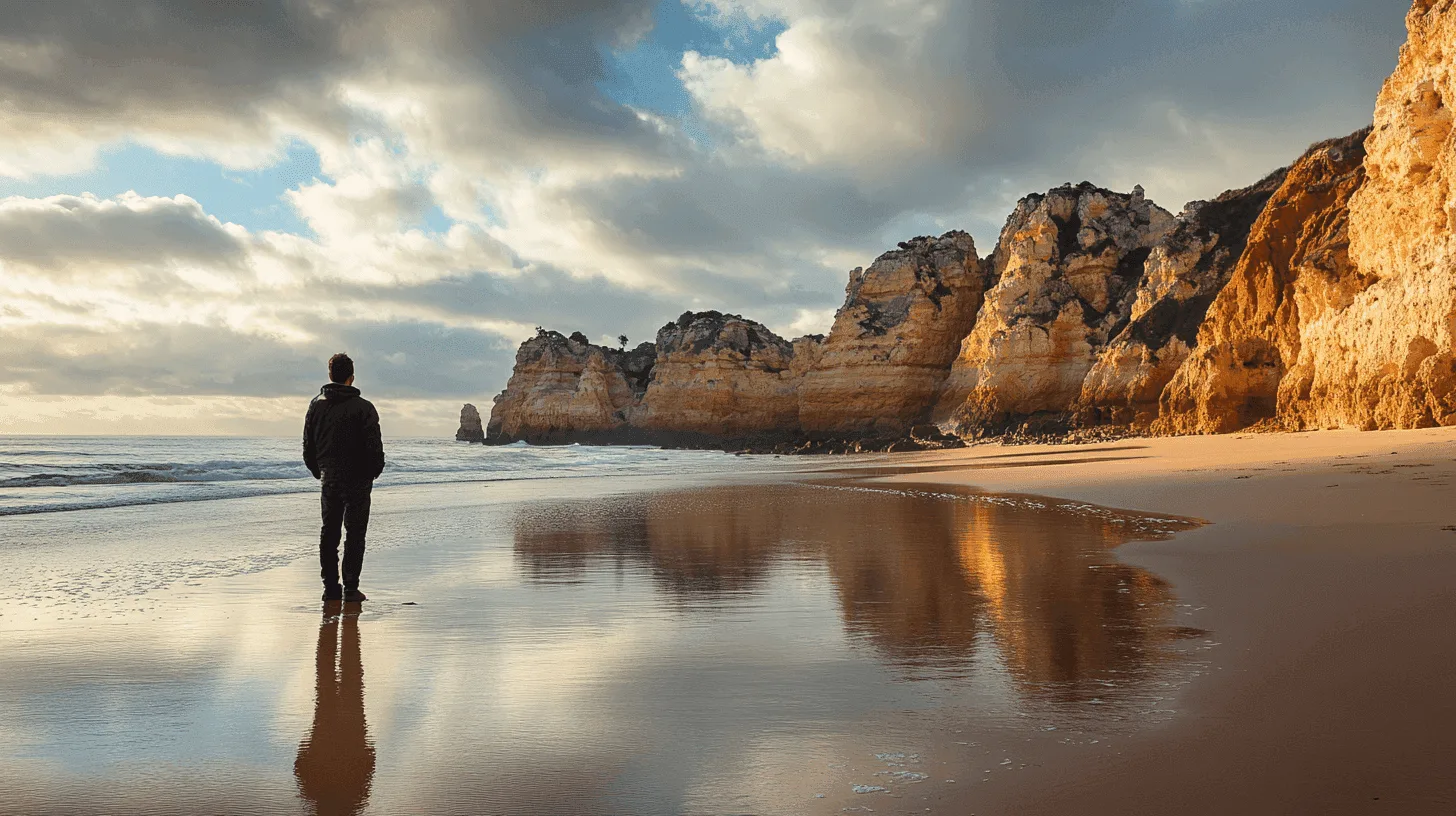 Winter sunlight on an empty Algarve beach beneath sandstone cliffs