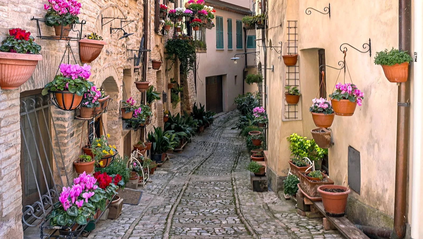 Narrow cobbled street of empty old houses in a rural Italian village
